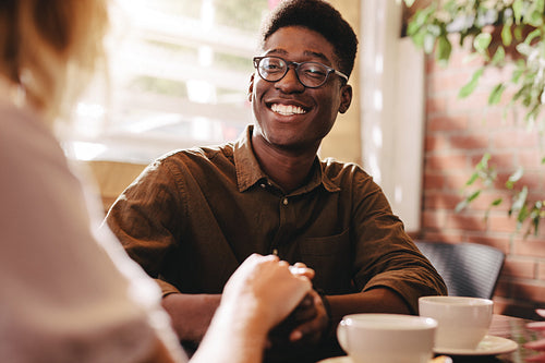Interracial couple on date at cafe