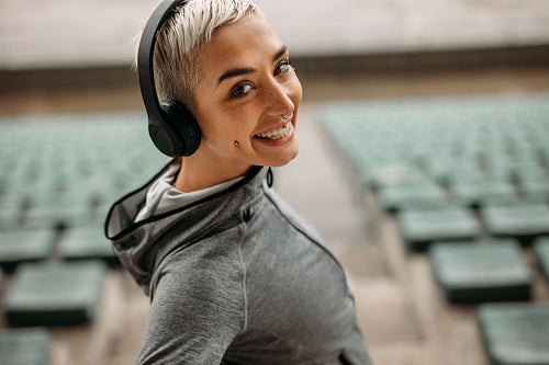 Close up of a smiling woman standing in a stadium