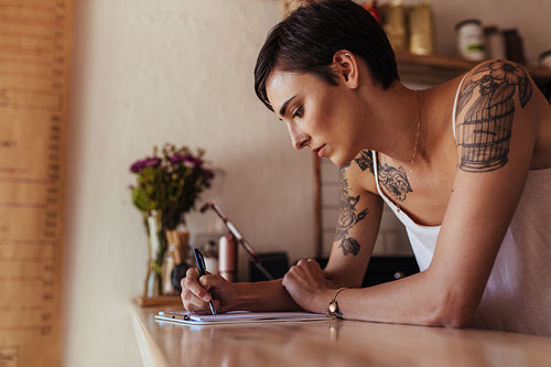 Woman entrepreneur standing at the counter of her cafe