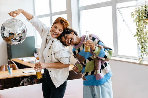 Colleagues enjoying a break with disco ball at office