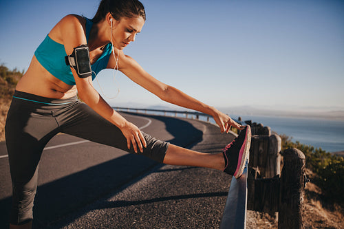 Female runner stretching before running