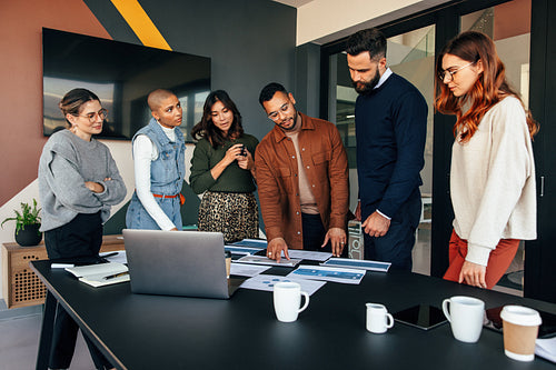 Team of businesspeople discussing some documents in a boardroom