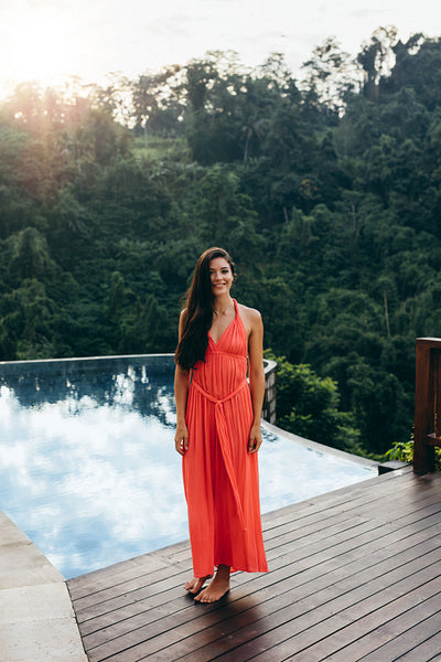Attractive young woman standing near swimming pool