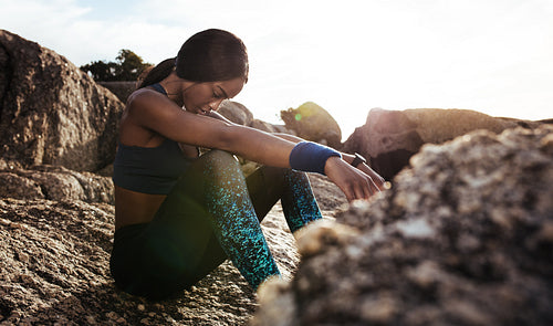 Female athlete taking rest after fitness training