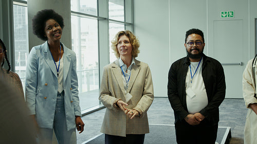 Diverse business professionals applauding during a conference or corporate event