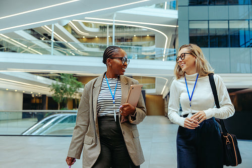 Successful young accountants walking and talking in a modern office environment