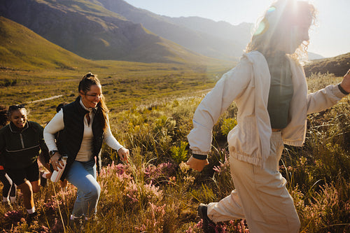 Friends hiking through scenic mountain trail