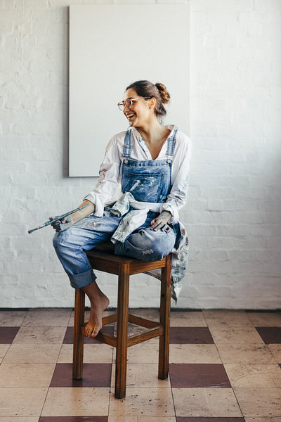 Happy young painter looking away with a smile