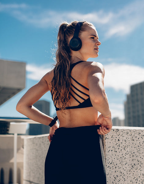 Female athlete in sportswear and headphones 