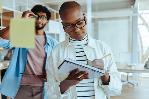 Creative business woman leading brainstorming session with colleagues in office