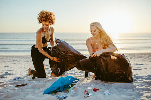 Female volunteers cleaning the beach
