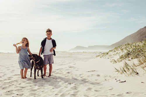 Kids at the beach with their pet