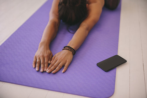 Woman doing stretching workout on exercise mat