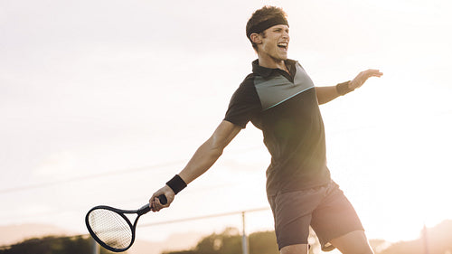 Professional tennis player hitting a forehand winner