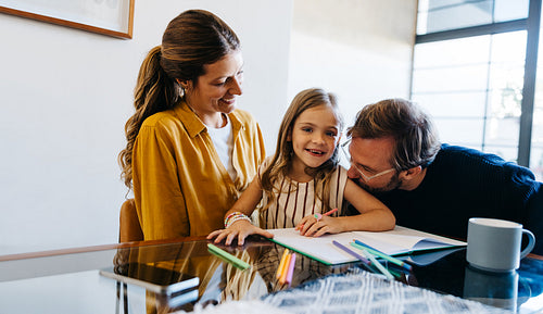 Family study session at home with smiling girl