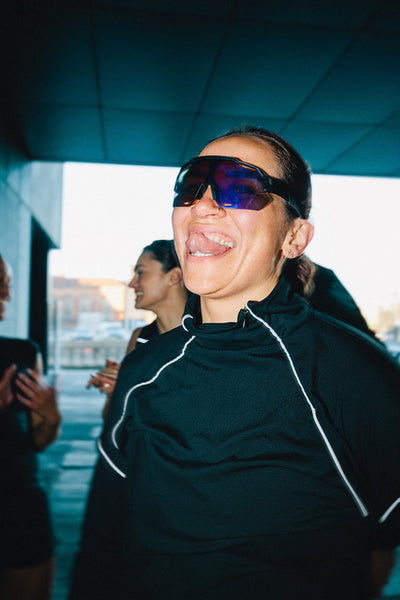 Female runner with sunglasses enjoying run club gathering