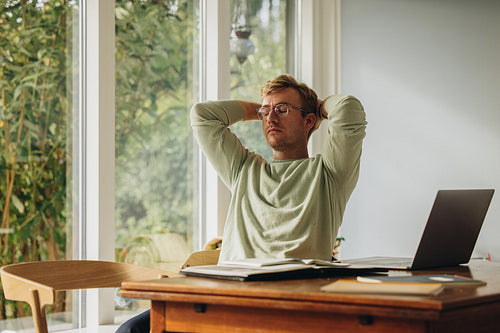Man at home taking break from work