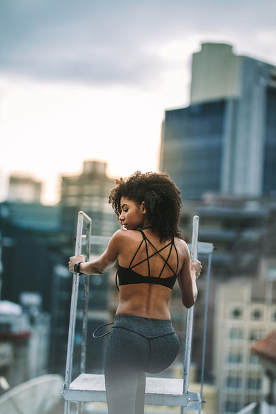 Afro american fitness woman doing workout on rooftop