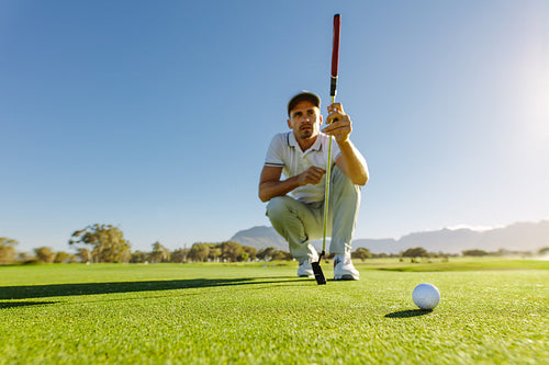 Golfer study the green before putting shot