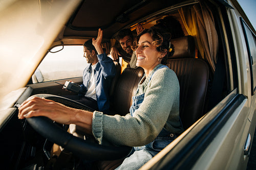 Smiling driver and passengers share laughter in vehicle