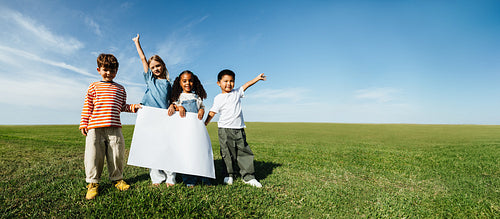Children outdoors with blank board group photo