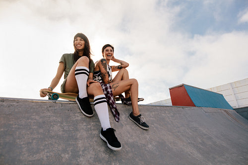 Urban girls in skate park laughing and having fun