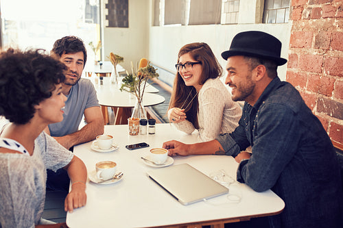Group of young friends hanging out at a cafe