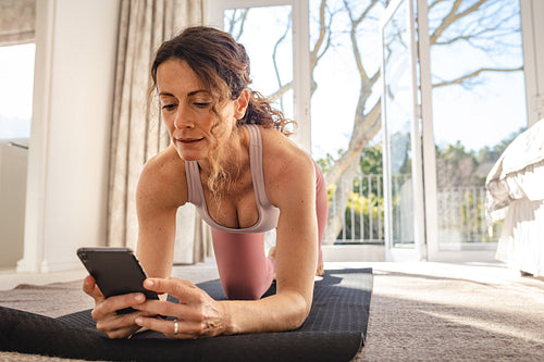 Woman perform yoga on mat using online session