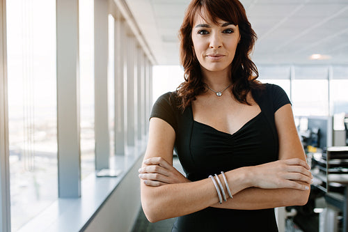 Confident businesswoman standing in office