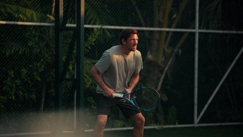 Man playing intense tennis game, demonstrating active and dynamic sports fitness
