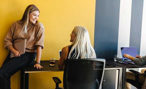 Young professionals interacting in a modern workspace setting with vibrant colors