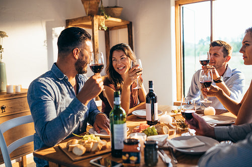 Group of friends enjoying meal at home together