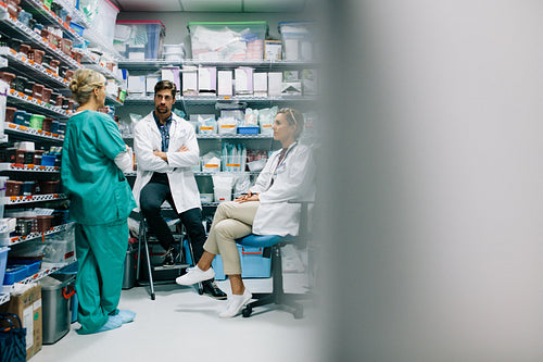 Hospital staff discussing medication in the pharmacy