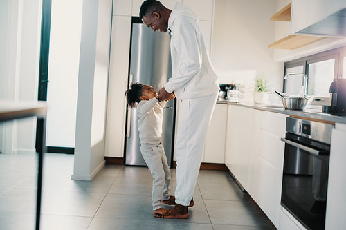 Dad and daughter playing in the kitchen
