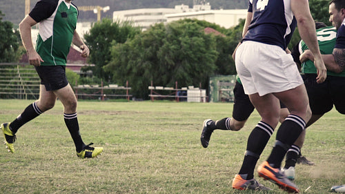Rugby players in action on pitch