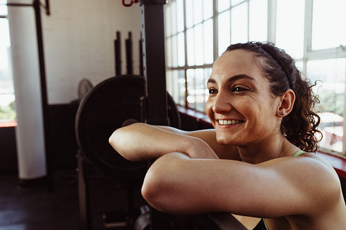 Woman resting after barbell training
