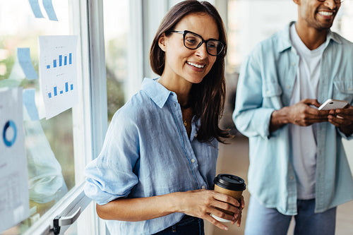 Female sales executive talking to her colleagues in an office