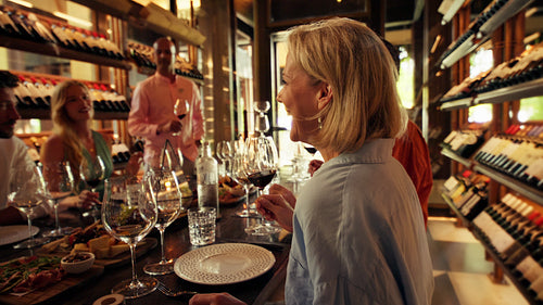 Friends toasting red wine in a private cellar during an exclusive tasting