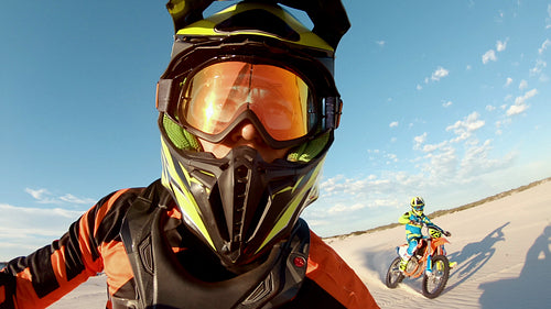 Cross country athlete racing ahead of his competitor in a desert