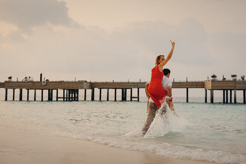 Sunset celebration: Mature newlyweds embracing romantic joy by the pier