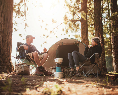 Mature couple camping by a lake