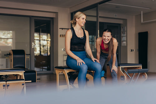 Happy pilates women at a gym taking a break during workout