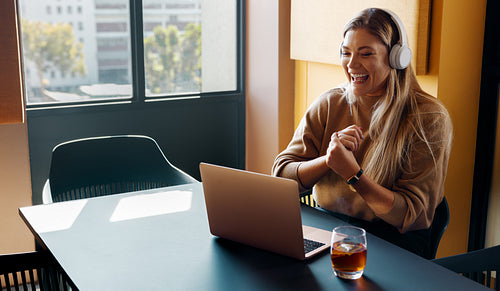 Young woman enjoying a remote online meeting in a bright modern office
