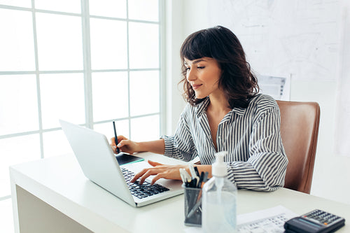 Female entrepreneur working in office
