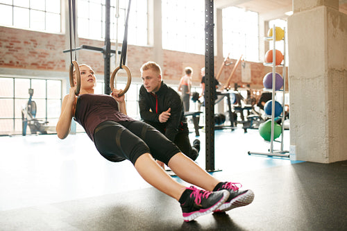 Personal trainer helping woman on her work out routines