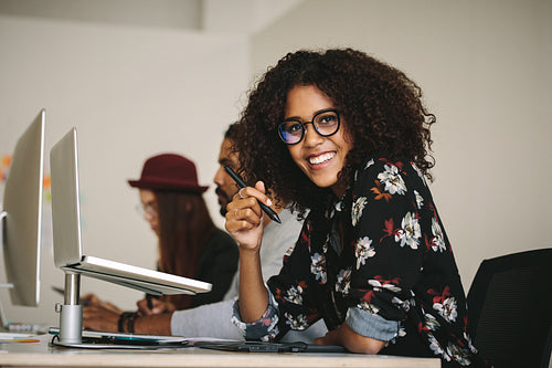 Smiling businesswoman holding a digital pen