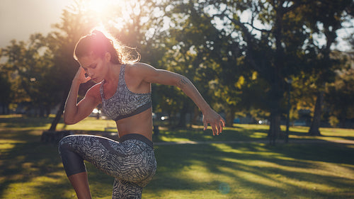 Fitness woman warming up at the park on a sunny day