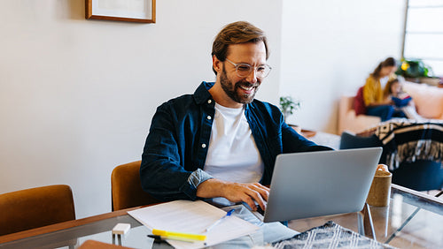 Professional man working on laptop at home