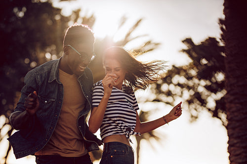 Couple of friends dancing outdoors