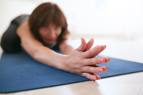 Woman doing stretching workout on yoga mat
